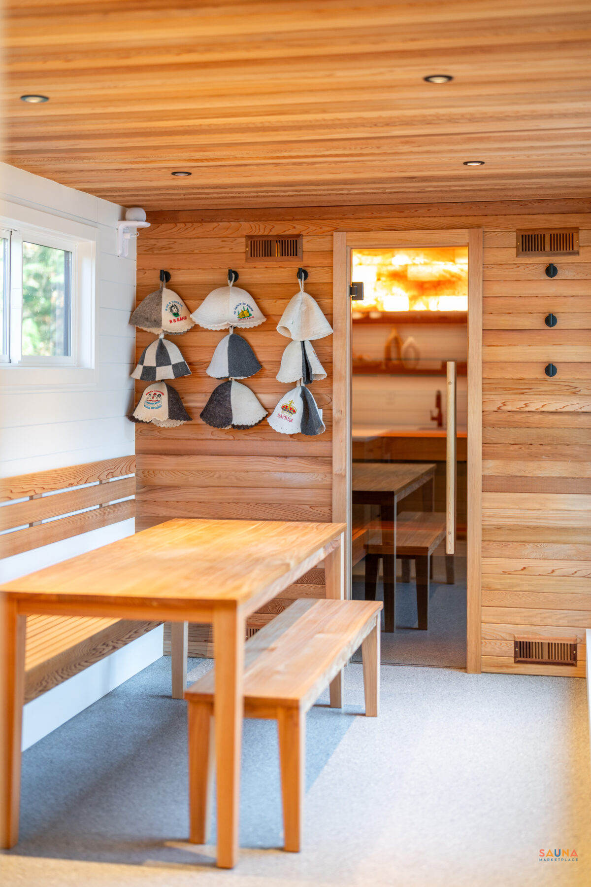 Mobile Spa On Wheels Entryway And Sauna Hats On Display With Table