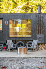 Woodburning mobile sauna outside patio seating