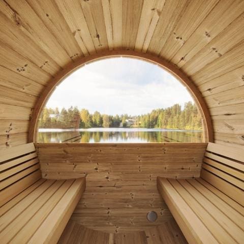 Interior view of the SaunaLife 4-Person Barrel Sauna Kit, showcasing the optional rear panoramic window, providing an enhanced atmosphere and picturesque view from inside the sauna