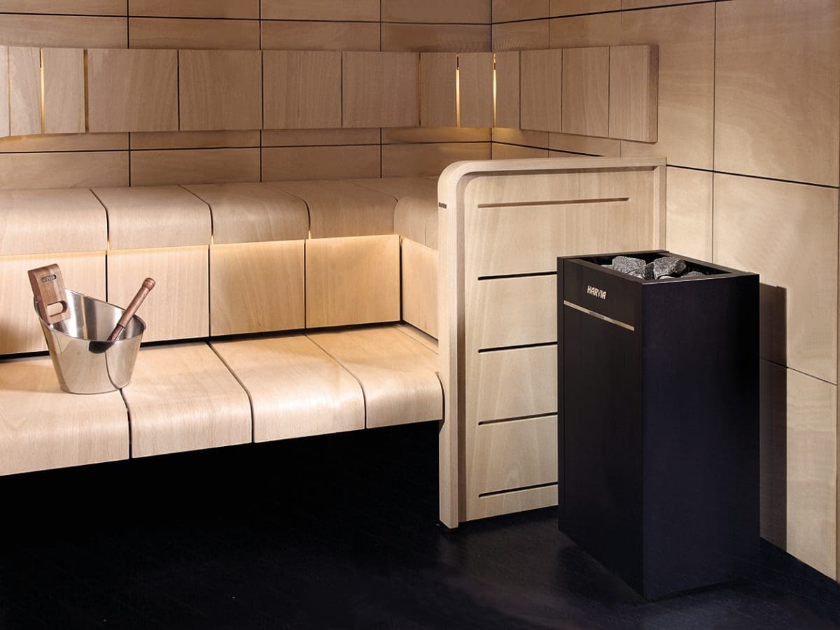 Harvia Virta Standalone Electric Sauna Heater In The Corner Of A Modern Sauna With Light Clear Wood Benches