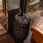 Cozy Through Wall (Into Changing Room) Wood Stove including rocks and chimney