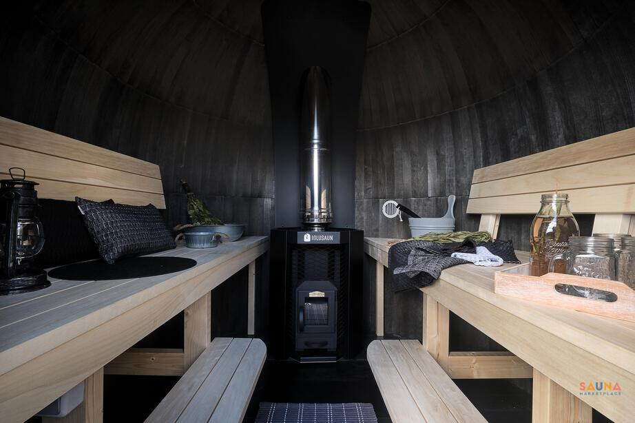 Curved steam room with aspen benches and wood stove