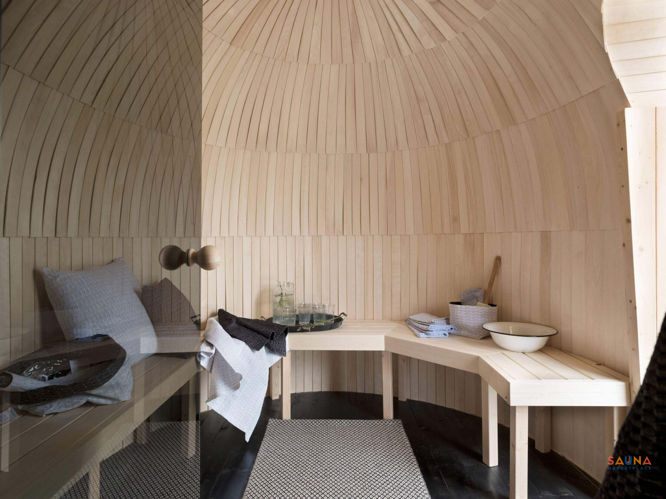 Triple Iglusauna entry lounge with light Aspen benches and window light